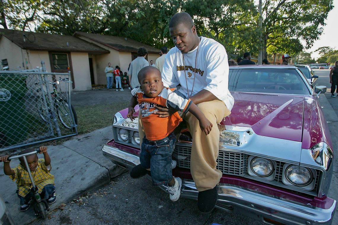 Now-retired NFL great Frank Gore plays with his son, Frank Gore Jr., outside his childhood home in the historically Black section of Coconut Grove while he played at the University of Miami in 2005. The younger Gore is now a running back at Southern Miss.