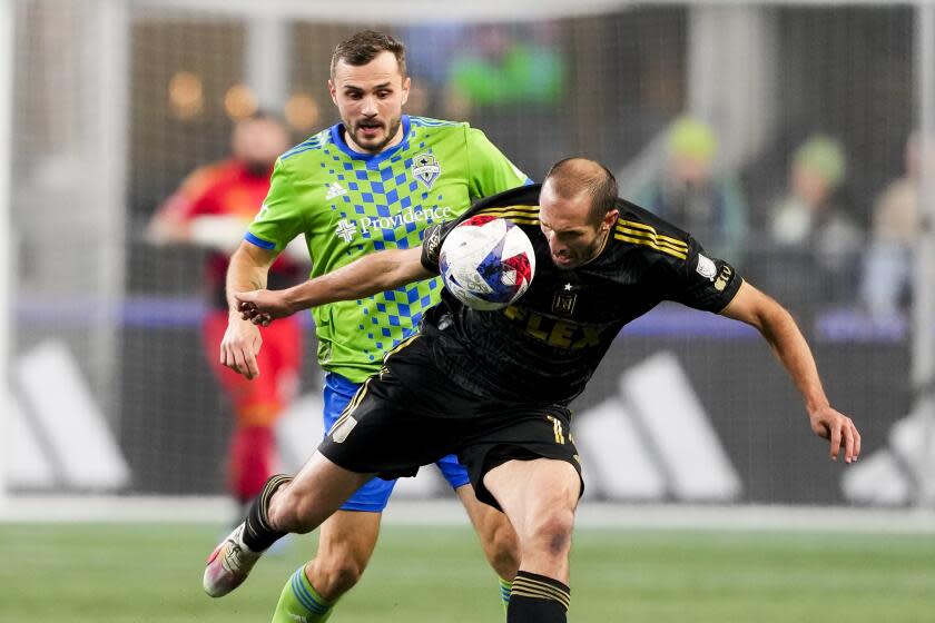 Seattle Sounders forward Jordan Morris, left, and Los Angeles FC defender Giorgio Chiellini, right, vie for the ball during the first half of an MLS conference semifinal playoff soccer match Sunday, Nov. 26, 2023, in Seattle. (AP Photo/Lindsey Wasson)