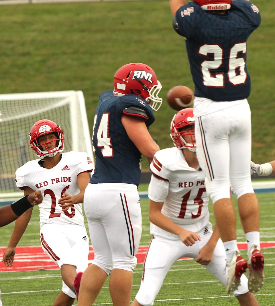 Bedford North Lawrence's Greg Gilbert, (74) and Collin Whittaker (blue 26)  pressure Jeffersonville kicker Kyon Stephenson (white 26) on a blocked field goal last season. Both defenders return for the Stars and will be in action Friday night at home in the scrimmage against Mitchell.
(Photo: Garet Cobb/Correspondent)