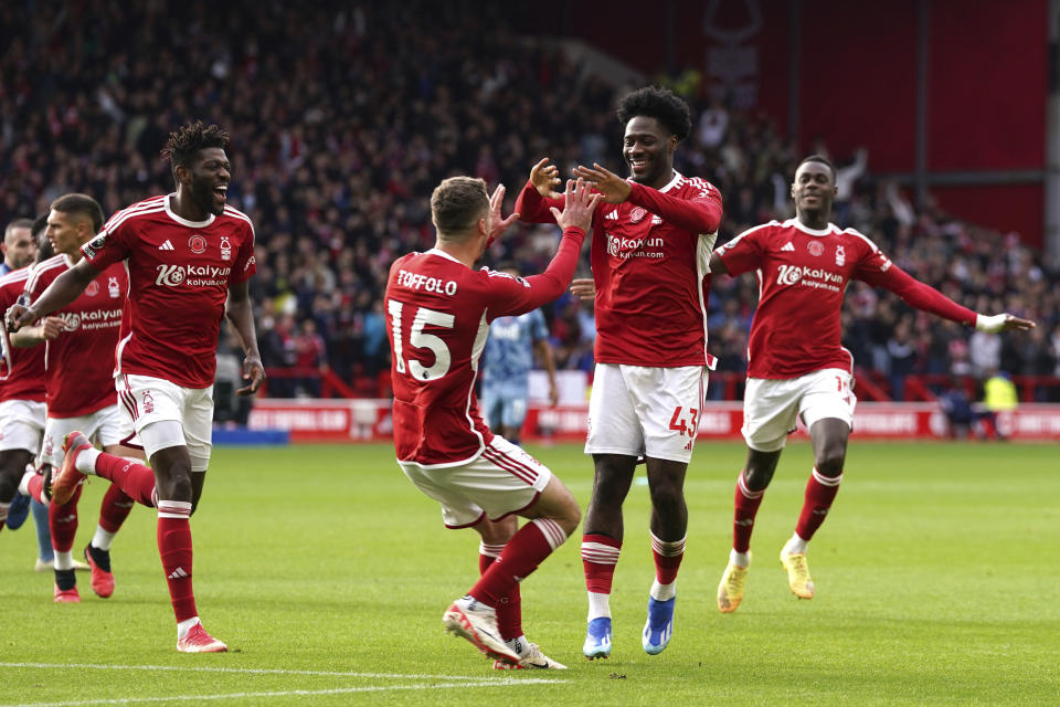 Nottingham Forest's Ola Aina, second right, celebrates scoring their side's first goal of the game with teammates during the English Premier League soccer match at City Ground, Nottingham, England, Sunday, Nov. 5 2023. (Nick Potts/PA via AP)