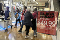 Black Friday shoppers walk through Macy's in Herald Square on Friday, Nov. 24, 2023, in New York. (AP Photo/Anne D'Innocenzio)