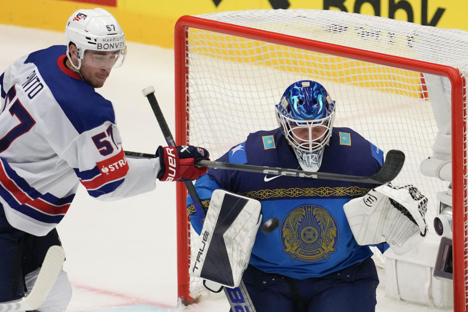 Kazakhstan's goalkeeper Nikita Boyarkin, right, makes a save in front of Unted States' Shane Pinto during the preliminary round match between United States and Kazakhstan at the Ice Hockey World Championships in Ostrava, Czech Republic, Sunday, May 19, 2024. (AP Photo/Darko Vojinovic)