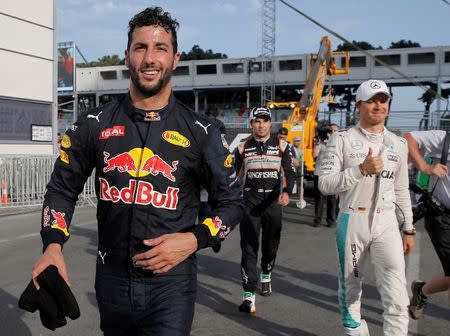 Formula One - Grand Prix of Europe - Baku, Azerbaijan - 18/6/16 - Red Bull Formula One driver Daniel Ricciardo of Australia, Force India Formula One driver Sergio Perez of Mexico and Mercedes Formula One driver Nico Rosberg of Germany walk in the paddock area after the qualifying session. REUTERS/Maxim Shemetov