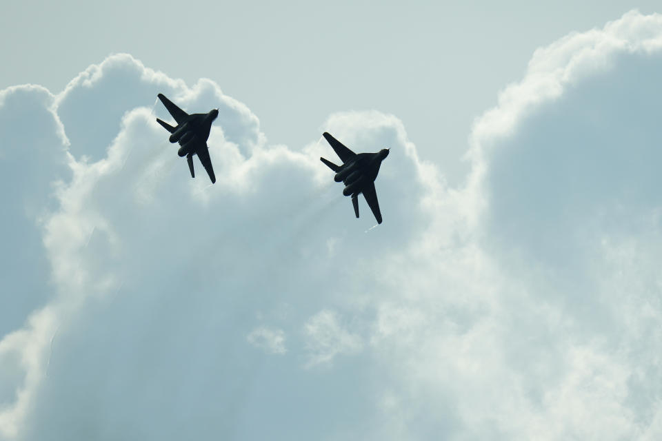 FILE - Slovak Air Force MiG-29s fly over an airport during an airshow in Malacky, Slovakia, Saturday, Aug. 27, 2022. Former Soviet satellite Slovakia has been a NATO member since 2004, but the reality of belonging to the world’s biggest military alliance really kicked in after Russia’s invasion of Ukraine a year ago. The small central European country now hosts thousands of NATO troops while allied aircraft patrol its skies. (AP Photo/Petr David Josek, File)