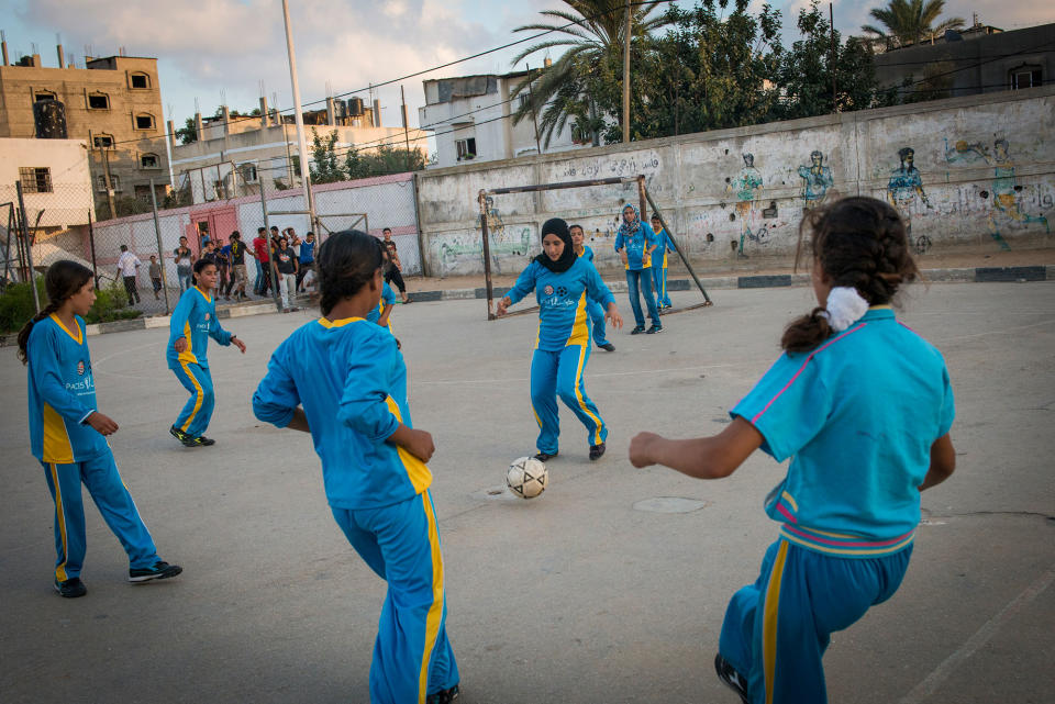 <p>Girls play football in the Northern Gaza town of Beit Lahiyah. Women in Gaza typically do all types of sports till the age of 16, when family pressure forces them to stop as many families seek to find husbands for them. (Photograph by Monique Jaques) </p>