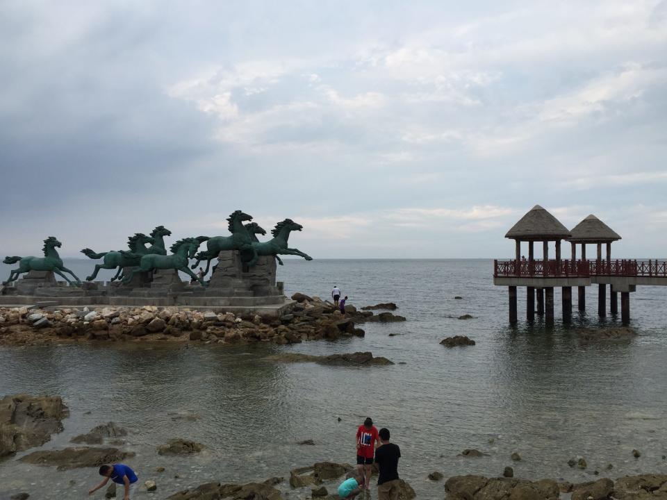 People by the water at Yangma Island in Yantai, China