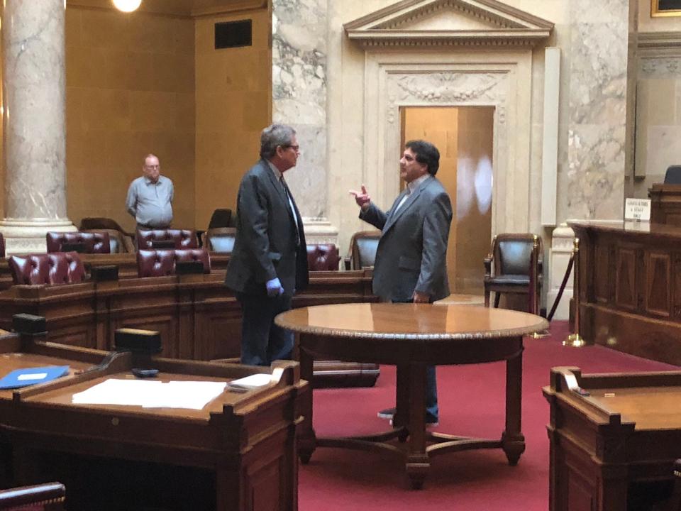 Wisconsin state Sen. Tim Carpenter, left, and Senate Clerk Jeff Renk attend a five-second-long special session on delaying the election  April 4 at the state Capitol in Madison. Only two of 33 members were present, and the Senate took no action but left open the option of returning April 6.