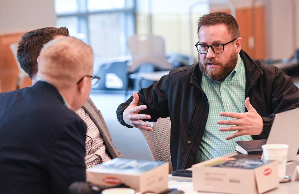 James Hoard, right, trustee, talks with fellow trustee Brian Aufmuth during the Greenville County Library Board of Trustees meeting at the Hughes Main Library in Greenville, S.C. Monday, December 5, 2022. 