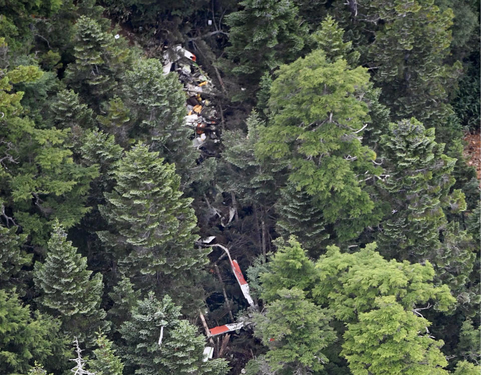 The wreckage of Gunma prefectural air rescue helicopter Haruna is seen after crashing in Nakanojo town, Gunma prefecture, northwest of Tokyo Friday, Aug. 10, 2018. The wreckage of the Japanese search and rescue helicopter with nine people aboard was found in central Japan mountains Friday hours after it lost contact, and two of them were found dead near the aircraft crash site. (Akiko Matsushita/Kyodo News via AP)