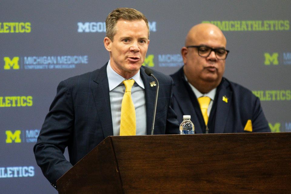 Michigan coach Dusty May answers a question next to athletic director Warde Manuel during an introductory press conference at Junge Family Champions Center in Ann Arbor on Tuesday, March 26, 2024.