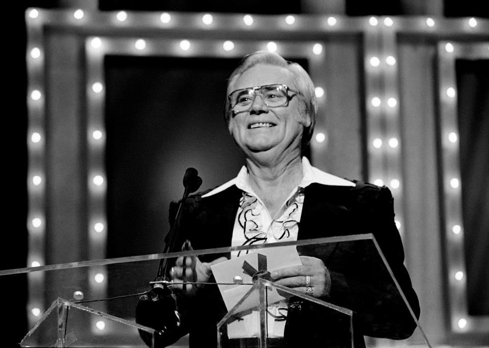 George Jones announces the winner of the Entertainer of the Year award during the 1989 Music City News Awards show at the Grand Ole Opry.