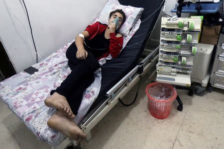 A civilian breathes through an oxygen mask at al-Quds hospital, after a hospital and a civil defence group said a gas, what they believed to be chlorine, was dropped alongside barrel bombs on a neighbourhood of the Syrian city of Aleppo, Syria, early August 11, 2016. REUTERS/Abdalrhman Ismail