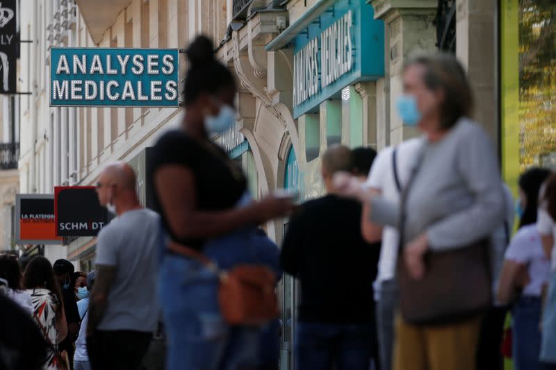 People queue to enter a laboratory to get tested for the coronavirus disease (COVID-19) in Neuilly-sur-Seine, near Paris