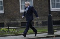 Britain's Prime Minister Boris Johnson returns to 10 Downing Street after meeting with Queen Elizabeth II at Buckingham Palace, London, on Friday, Dec. 13, 2019. Prime Minister Boris Johnson's Conservative Party has won a solid majority of seats in Britain's Parliament — a decisive outcome to a Brexit-dominated election that should allow Johnson to fulfil his plan to take the U.K. out of the European Union next month. (AP Photo/Matt Dunham)