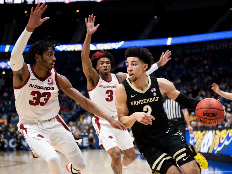 Vanderbilt guard Scotty Pippen Jr. (2) drives past Arkansas guard Jimmy Whitt Jr. (33) and Arkansas guard Desi Sills (3) during a basketball game between the Vanderbilt Commodores and the Arkansas Razorbacks during the SEC Basketball Tournament held at Bridgestone Arena in Nashville, Tenn., on Wednesday, March 11, 2020.