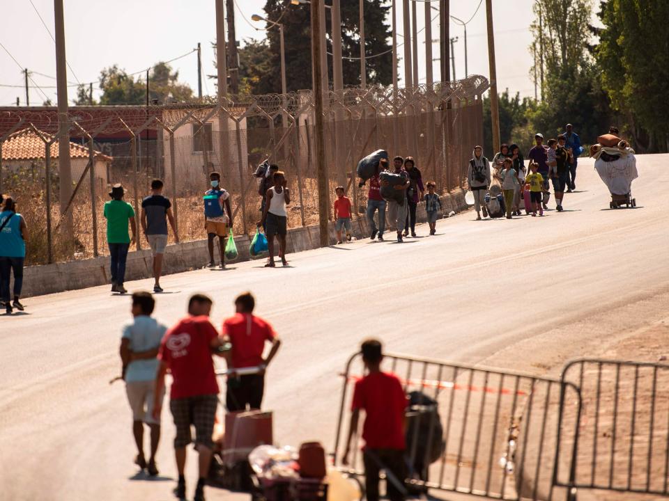 Migrants enter a new temporary camp near Panagiouda, hosting refugees and migrants from the Moria camp destroyed by a fire on the night of September 8th  (Angelos Tzortzinis/ AFP)