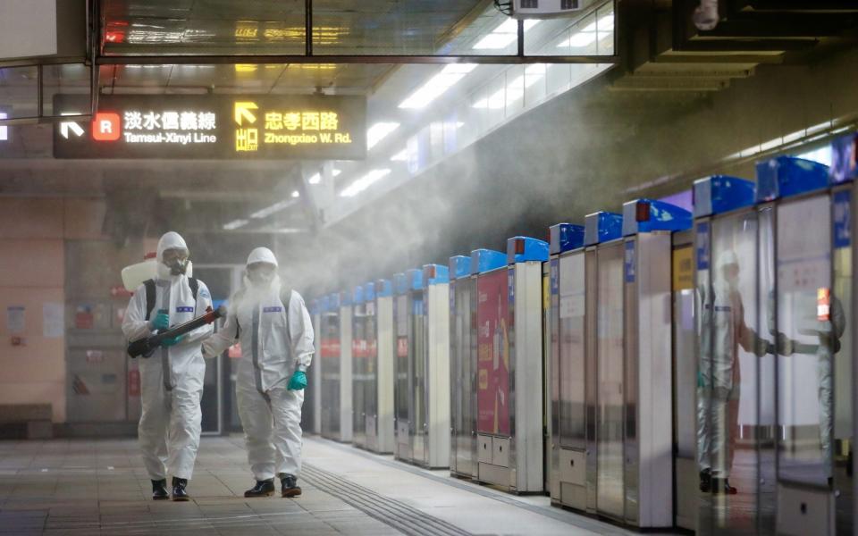 Military personnel spray anti-Covid disinfectant inside the Taipei Main Station - RITCHIE B TONGO/EPA-EFE/Shutterstock 