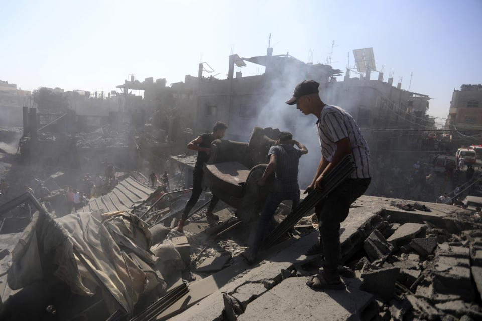 Palestinians inspect the rubble of destroyed buildings following Israeli airstrikes on town of Khan Younis, southern Gaza Strip, Thursday, Oct. 26, 2023. (AP Photo/Mohammed Dahman)