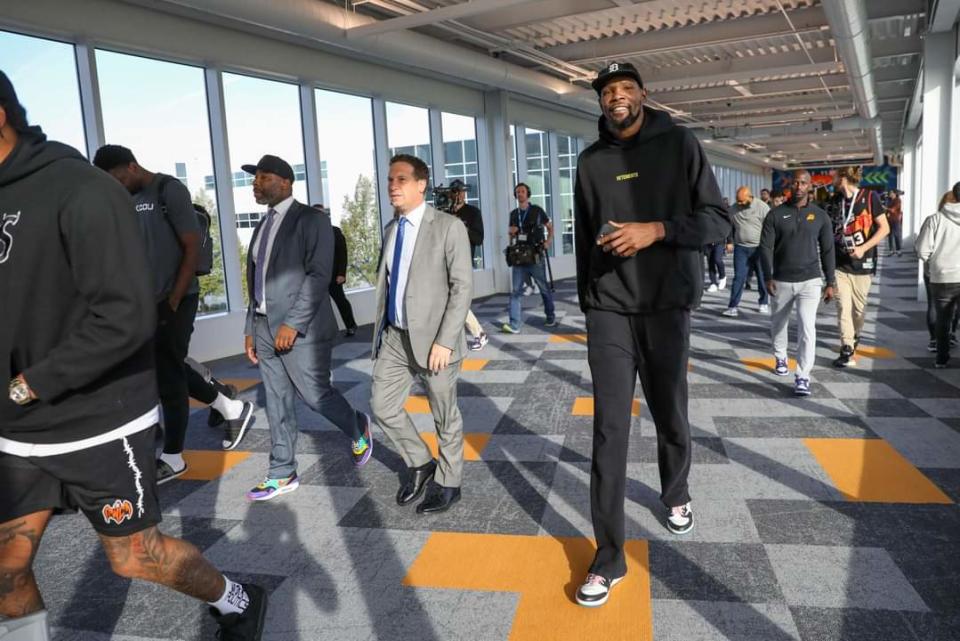 Phoenix Suns superstar Kevin Durant walks beside team owner Mat Ishbia through the United Wholesale Mortgage campus on Oct. 9, 2023, in Pontiac, Michigan.