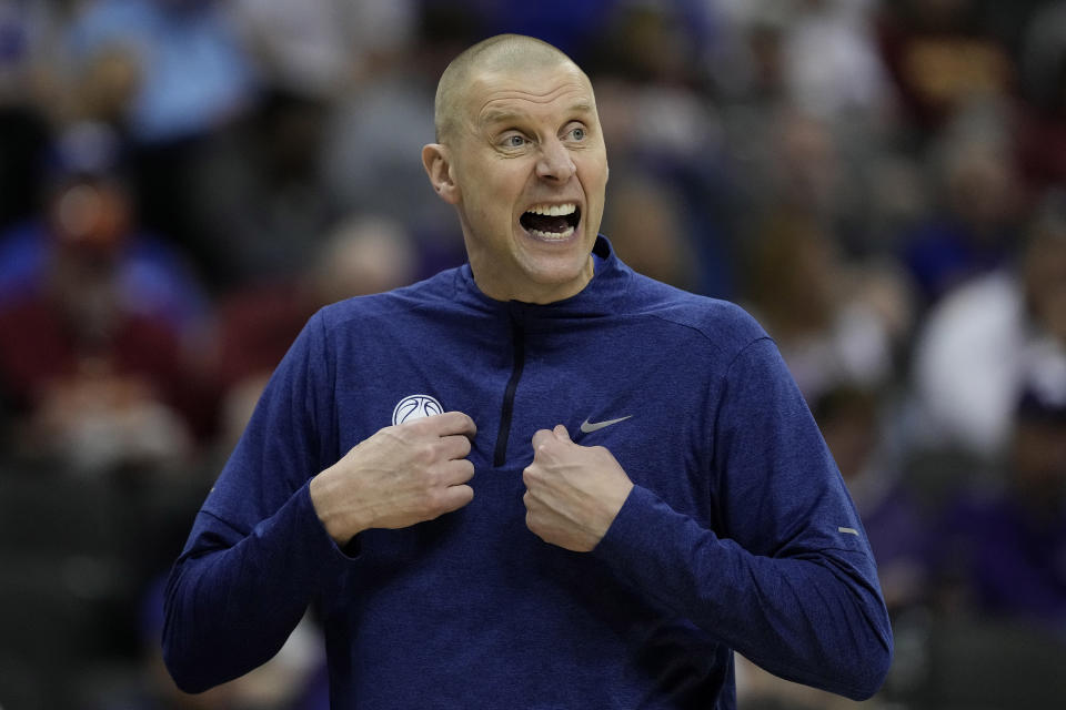 FILE - BYU head coach Mark Pope talks to his players during the first half of an NCAA college basketball game against UCF Wednesday, March 13, 2024, in Kansas City, Mo. Kentucky has hired BYU’s Mark Pope as men’s basketball coach, bringing home a member of the Wildcats’ 1996 national championship team to succeed John Calipari. The school announced Pope’s hiring in a release Friday morning, April 12, but did not mention any contract details. The 51-year-old Pope will be introduced at a later date, the release said. (AP Photo/Charlie Riedel, File)