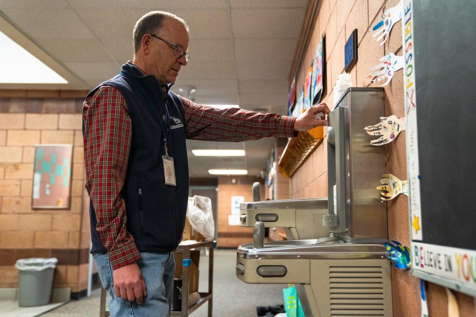 John Holcombe, environmental coordinator for PSD, collects a water sample from a drinking fountain at Johnson Elementary School on March 30, 2023, in Fort Collins.