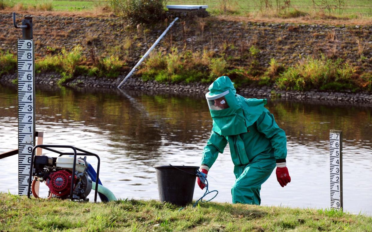 An Environment Agency worker treating the River Trent - Rui Vieira/PA Wire