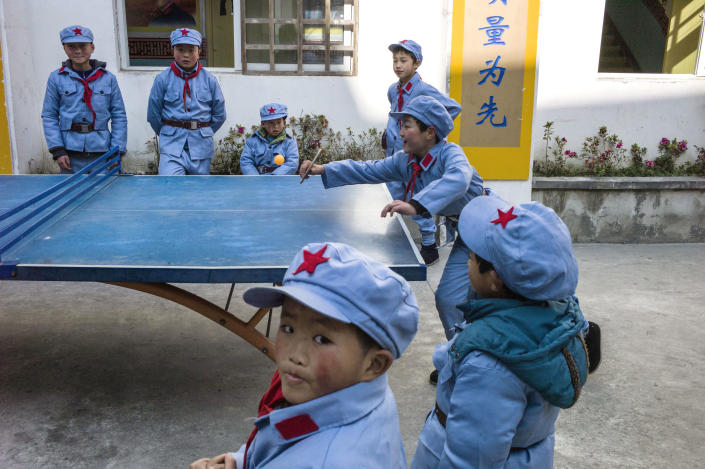 Children dressed in uniforms play table tennis during a break between the lessons, at the Beichuan Red army elementary school, in south-west China's Sichuan province (AFP Photo/Fred Dufour)
