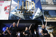 Lido cabaret dancers perform on the Champs-Elyses avenue during a demonstration to try to save their jobs and the history of the cabaret, known for its dinner theater and its "Bluebell Girls" revue, Saturday, May 28, 2022 in Paris. Amid financial troubles and changing times, the venue's new corporate owner is ditching most of the Lido's staff and its high-kicking, high-glamour dance shows — which date back decades and inspired copycats from Las Vegas to Beirut — in favor of more modest musical revues. (AP Photo/Thomas Padilla)