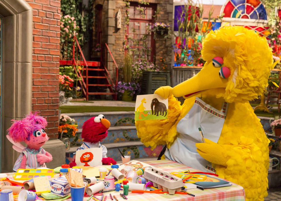 This image released by HBO shows characters, from left, Abby Cadabby, Elmo and Big Bird in a scene from "Sesame Street." The popular children's TV show is celebrating its 50th season. (HBO via AP)