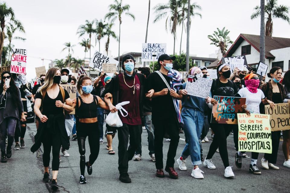 Scout Bassett (second from left) attends a protest in San Diego.