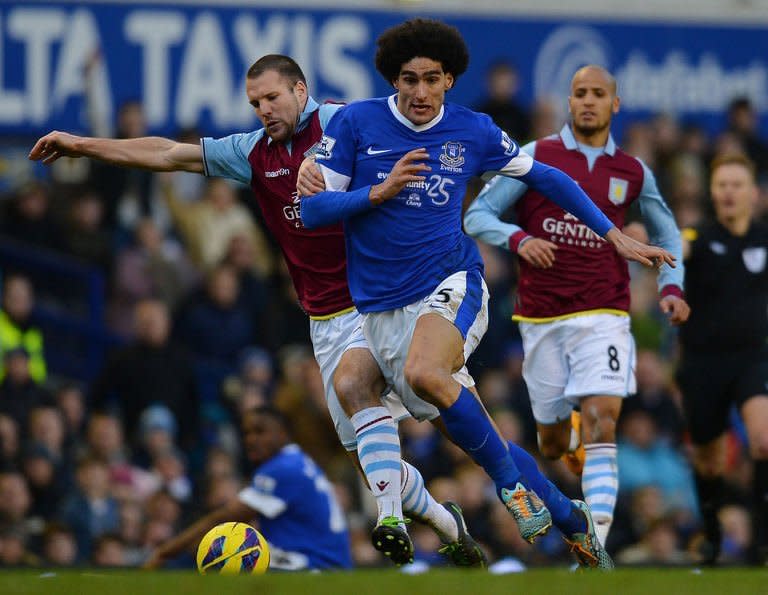 Aston Villa's defender Ron Vlaar (L) clashes with Everton's midfielder Marouane Fellaini during their English Premiership football match at Goodison Park in Liverpool, north-west England on February 2, 2013. The match ended in a 3-3 draw