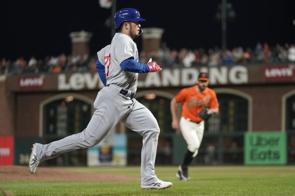 Chicago Cubs' Seiya Suzuki runs home to score in front of San Francisco Giants pitcher Ryan Walker during the seventh inning of a baseball game in San Francisco, Friday, June 9, 2023. (AP Photo/Jeff Chiu)