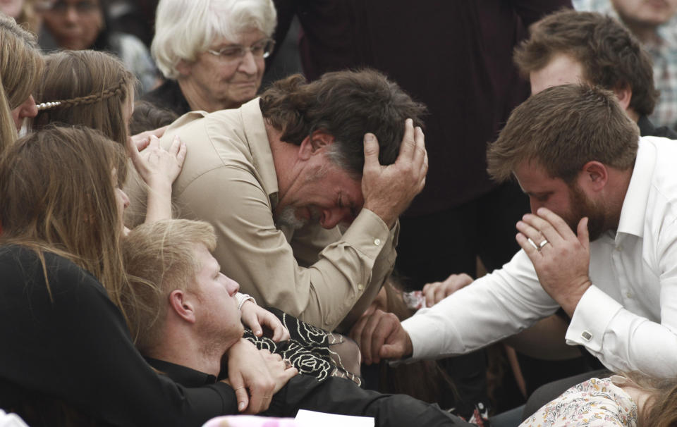 CORRECTS RELATION TO DAWNA - David Langford is consoled during the funeral service for his wife Dawna Ray and their two sons, in La Mora, Mexico, Thursday, Nov. 7, 2019. As Mexican soldiers stood guard, Dawna Ray Langford and her sons Trevor, 11, and Rogan, 2, were laid to rest in a single grave at the first funeral for the victims of a drug cartel ambush that left nine American women and children dead. (AP Photo/Christian Chavez)