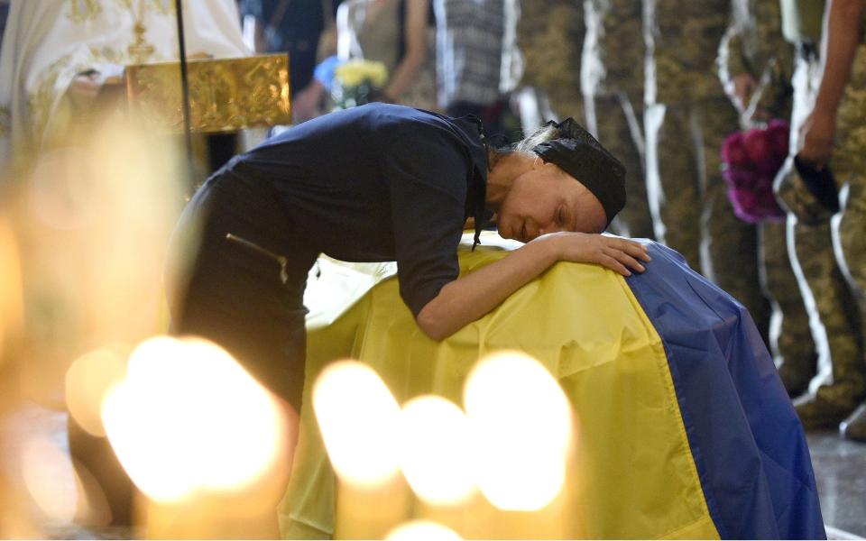 A woman mourns at Ukrainian soldier Roman Barvinok-Skrypal's funeral service at St Michael's Cathedral, Kyiv -  Ruslan Kaniuka/Ukrinform/NurPhoto/Shutterstock