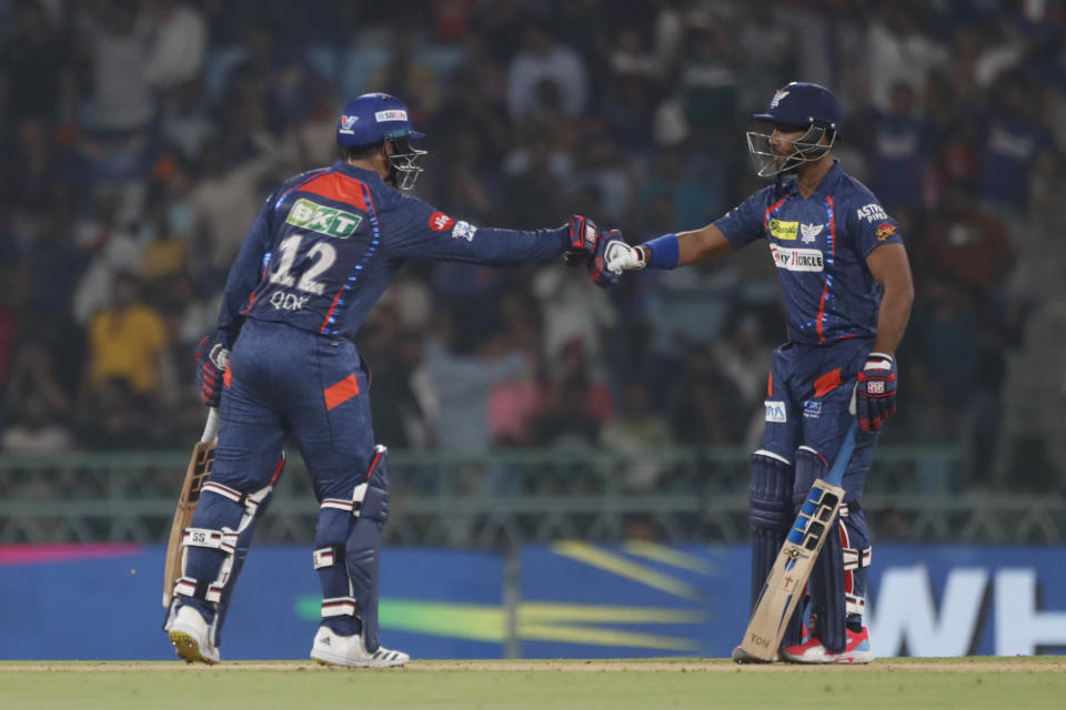 Lucknow Super Giants' Quinton de Kock, left, fist bumps with batting partner Nicholas Pooran during the Indian Premier League cricket match between Lucknow Super Giants and Punjab Kings in Lucknow, India, Saturday, March 30, 2024.(AP Photo/Pankaj Nangia)