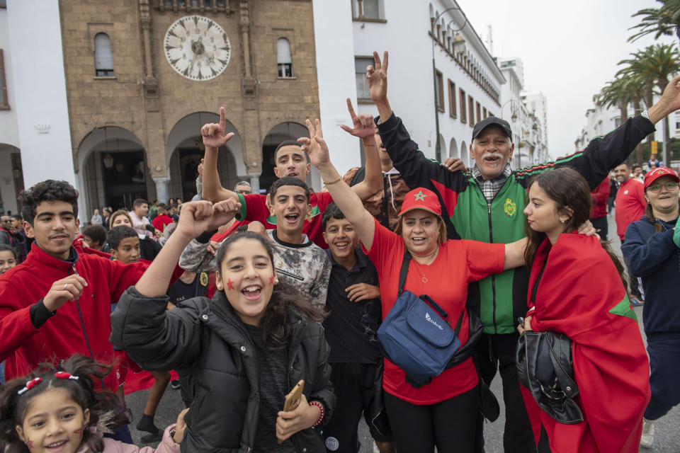 Morocco soccer fans react while watching their national team defeat Belgium 2-0 in a World Cup soccer match played in Qatar, in Rabat, Morocco, Sunday, Nov. 27, 2022. (AP Photo)