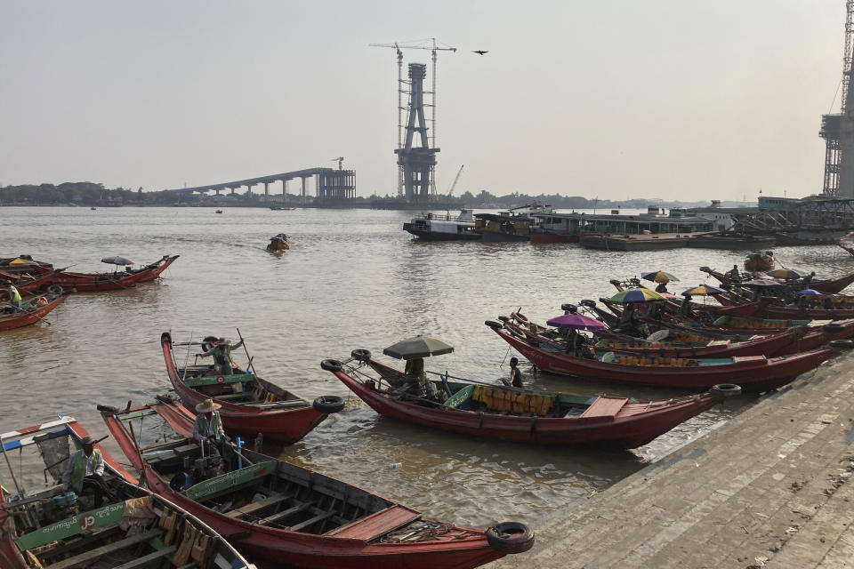 Ferry boat drivers wait for passengers to cross Yangon river, at a jetty in Yangon, Myanmar, Monday, April 29, 2024. (AP Photo)