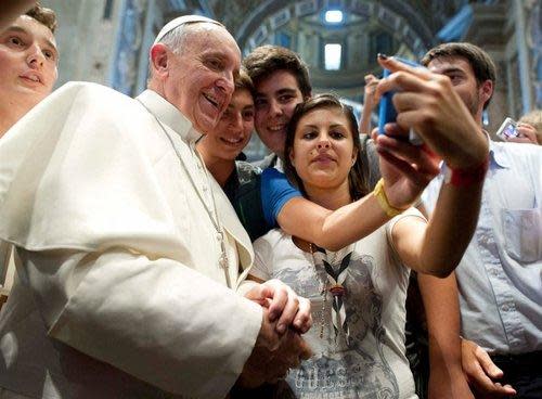 Teens taking a selfie with the pope