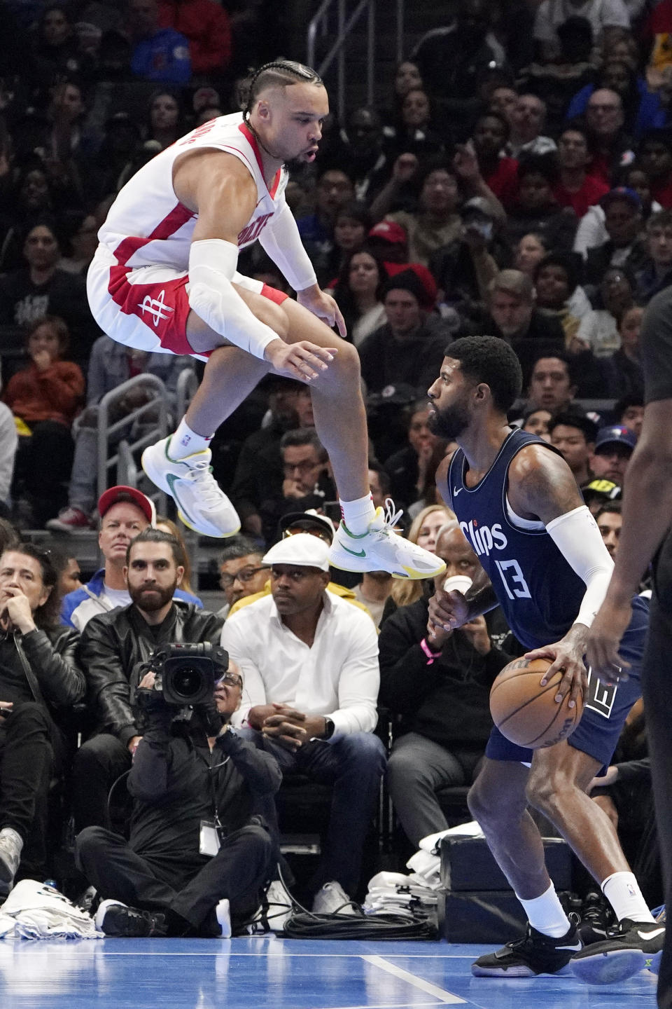 Los Angeles Clippers forward Paul George, right, gets set to shoot as Houston Rockets forward Dillon Brooks defends during the second half of an NBA basketball In-Season Tournament game Friday, Nov. 17, 2023, in Los Angeles. (AP Photo/Mark J. Terrill)