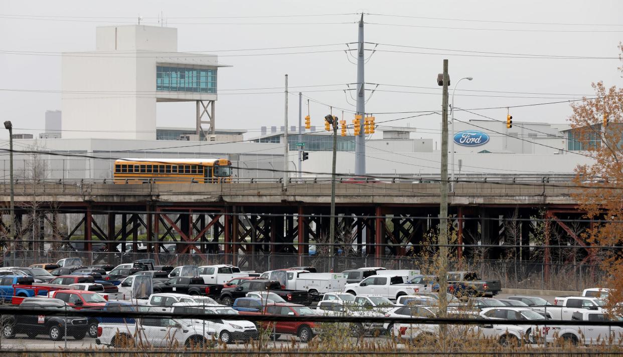 A school bus and other vehicles cross over the Miller Road Bridge in Dearborn with part of the Ford Motor Company Dearborn Truck Plant in the background on Thursday, April 2, 2019.