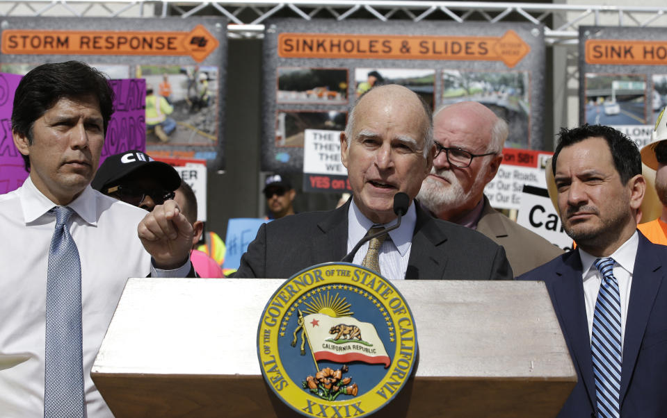 California Gov. Jerry Brown, center, urges lawmakers to approve a plan for a $5 billion-a-year tax and fee road repair measure during a rally Wednesday, April 5, 2017, in Sacramento, Calif. The bill, SB1, supported by Brown and Democratic Legislative leaders, Senate President Pro Tem Kevin de Leon, left, and Assembly Speaker Anthony Rendon, right, is expected to be voted on by the California Legislature on Thursday. (AP Photo/Rich Pedroncelli)