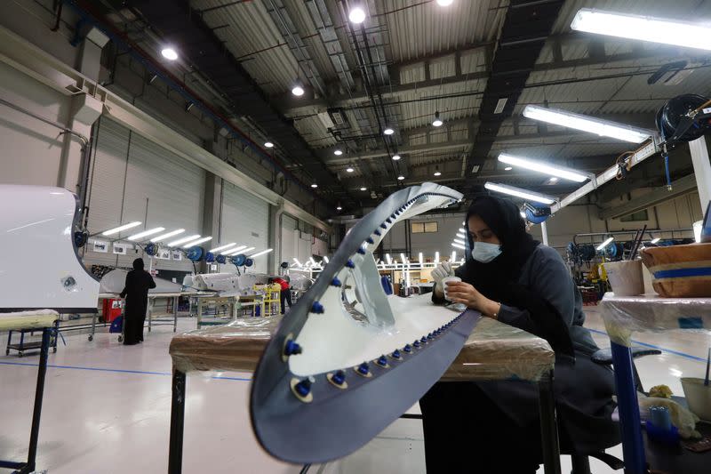 A worker details a plane part made at the Strata Manufacturing facility, in Al Ain