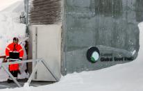 FILE PHOTO: A guard stands watch outside the Global Seed Vault before the opening ceremony in Longyearbyen in the Arctic