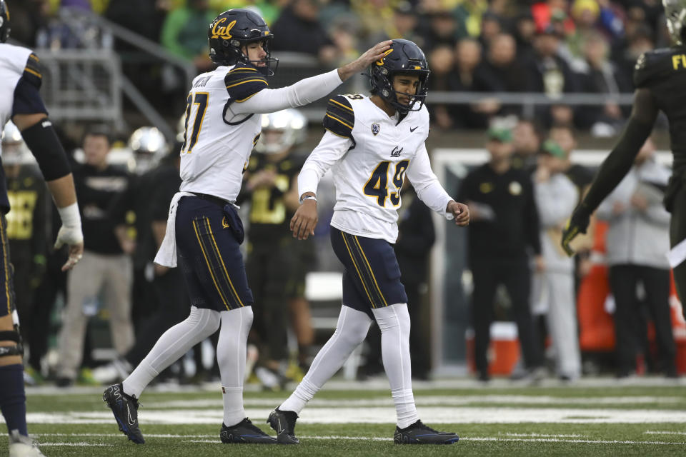 California place kicker Mateen Bhaghani (49) celebrates after kicking a field goal with teammate Lachlan Wilson (37) during the first half of an NCAA football game against Oregon, Saturday, Nov. 4, 2023, in Eugene, Ore. (AP Photo/Amanda Loman)