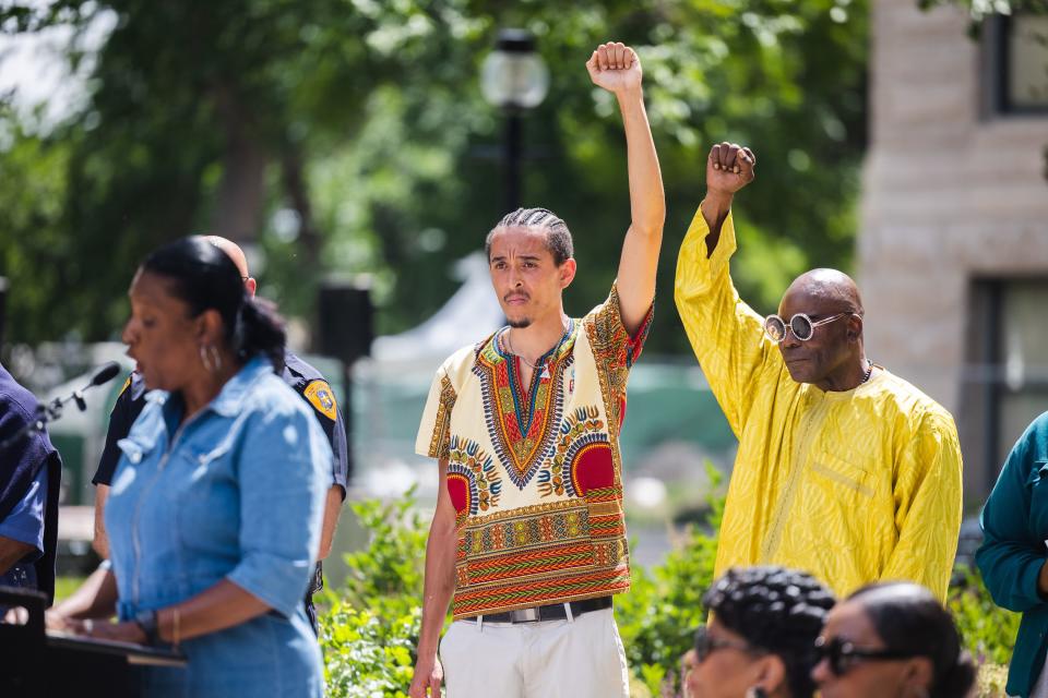 MJ Powell and Everett “The Messenger” Spencer, left to right, raise their fists during the flag-raising ceremony for Juneteenth at the Salt Lake City and County Building in Salt Lake City on June 19, 2023. | Ryan Sun, Deseret News