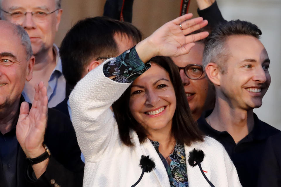 Paris mayor Anne Hidalgo waves before delivering a speech after her victorious second round of the municipal election, Sunday, June 28, 2020 in Paris. France on Sunday held the second round of municipal elections that has seen a record low turnout amid concerns over the coronavirus outbreak and anger at how President Emmanuel Macron's government handled it. (AP Photo/Christophe Ena)