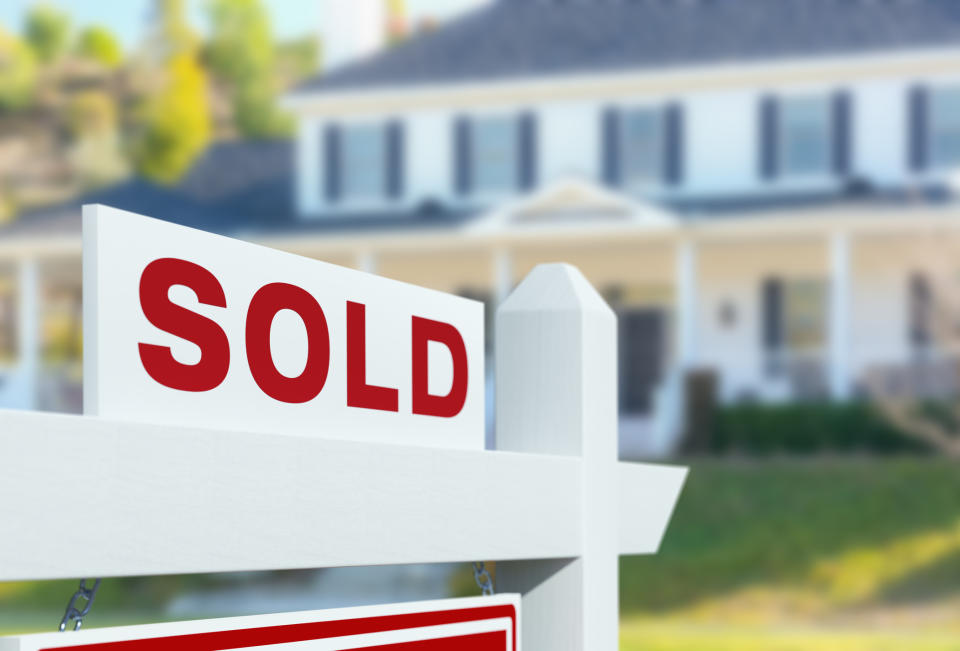 A sold sign in front of a house