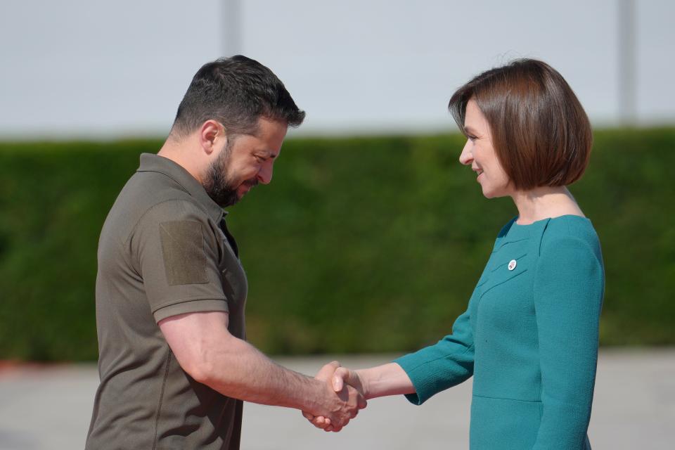 Moldova's President Maia Sandu, right, greets Ukraine's President Volodymyr Zelenskyy during arrivals for the European Political Community Summit at the Mimi Castle in Bulboaca, Moldova, Thursday, June 1, 2023.