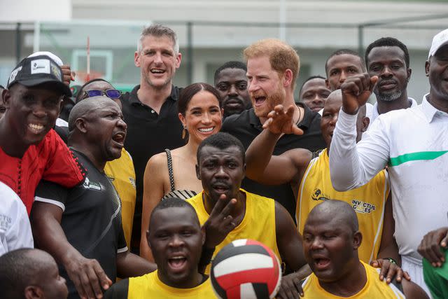 <p>KOLA SULAIMON/AFP via Getty</p> Meghan Markle and Prince Harry (center) before a exhibition sitting volleyball match at Nigeria Unconquered in Abuja, Nigeria, on May 11, 2024.