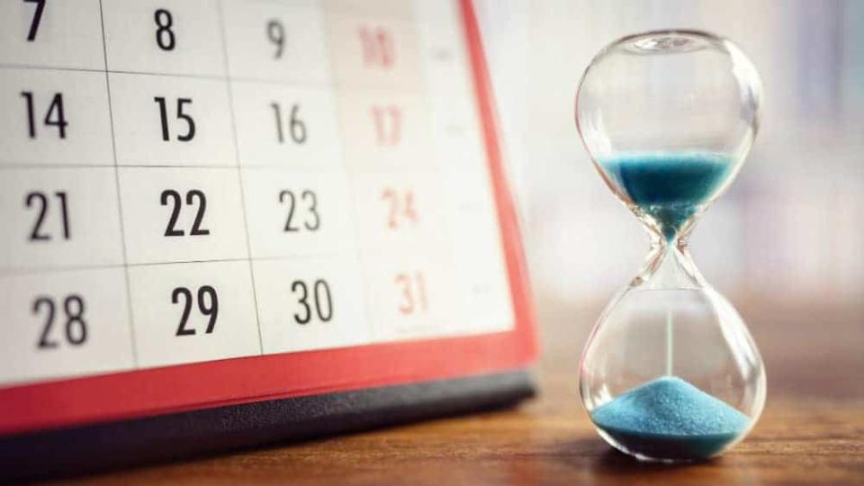 Hour glass and calendar concept for time slipping away for important appointment date, schedule and deadline